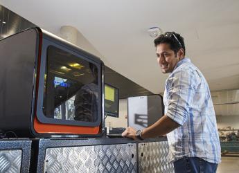 A mechanical engineering draftsperson creating parts using a 3D printer.