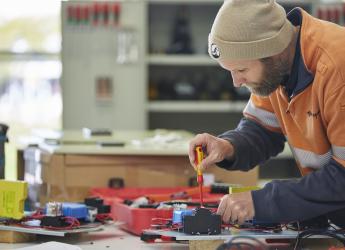 An electrician, installing an electrical control system.