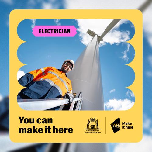 Male electrician in hi vis with windmill in the background